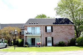 Amherst condo for rent - A red brick house with a white door and windows.