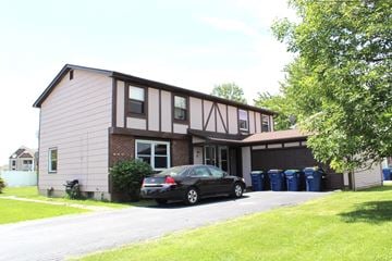 Amherst triplex for rent - A black car is parked in front of a house.