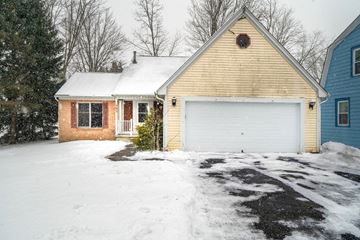 Amherst house for rent - A house with a white garage door in the snow.