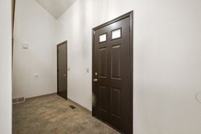 Amherst house for rent - A brown door is in a room with a brown floor.