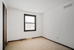 Amherst triplex for rent - A room with a window and a door.