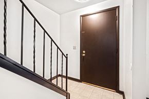 Amherst triplex for rent - A brown door is at the end of a hallway.