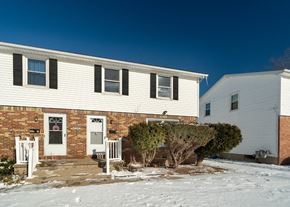 Amherst triplex for rent - A house with a white door and a small porch.