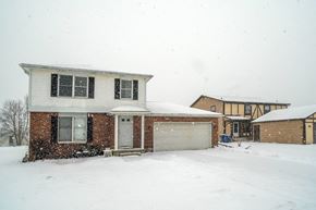 Amherst apartment for rent - A house with a white garage door and a brick wall.