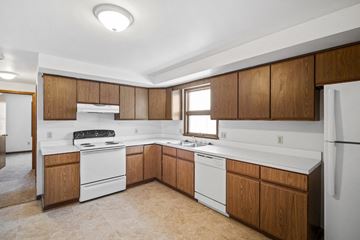 Amherst apartment for rent - A kitchen with white appliances and wooden cabinets.