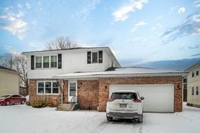 Amherst apartment for rent - A white car is parked in front of a house.