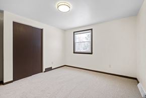 Amherst apartment for rent - A room with a brown door and a window with a white frame.