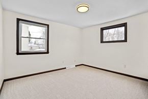 Amherst apartment for rent - A room with two windows and a carpeted floor.