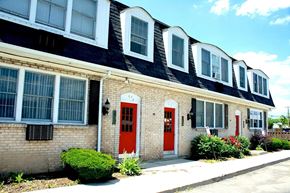 Tonawanda apartment for rent - A house with a red door and windows.