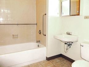 Buffalo apartment for rent - A white bathroom with a tub, sink, and toilet.