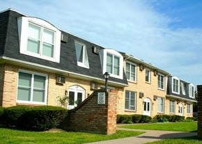 Buffalo apartment for rent - A brick building with a black roof and white trim.