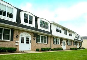 Amherst townhouse for rent - A row of houses with the first one having a white door.