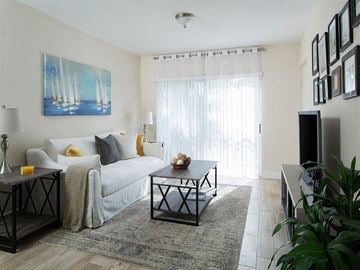 Miami apartment for rent - a living room with a couch and a table