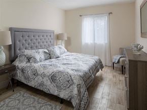 Miami apartment for rent - a bedroom with a bed and a desk and a window