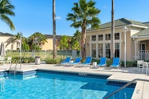 Miami apartment for rent - A pool with a building behind it.