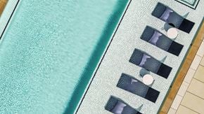 Dallas apartment for rent - A blue pool with a white line down the middle and a black and white striped pool in the background.