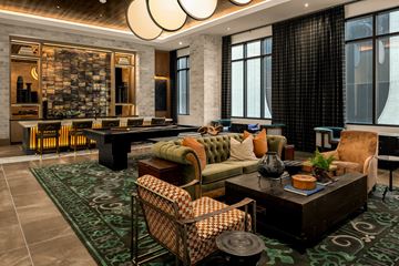 Nashville apartment for rent - A living room with a green rug and a brown coffee table.