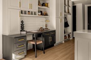 Nashville apartment for rent - A kitchen with black and white cabinets and a wooden floor.