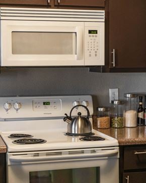 Las Vegas apartment for rent - a kitchen with a stove and microwave and a tea kettle on the stove
