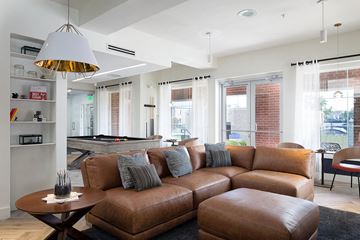 Kansas City apartment for rent - a living room with a leather couch and a pool table