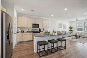 Katy apartment for rent - a kitchen and living room with a large island with three stools