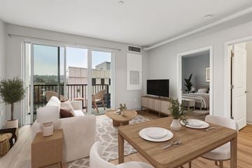Pittsburgh apartment for rent - A modern living room with a dining table set for two.