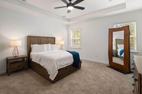 Grayson apartment for rent - Primary Bedroom with king size bed and large window letting in nice natural light.