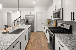 Lawrenceville apartment for rent - Spacious kitchen with an island, ample storage, stainless steel appliances and view into the living room.