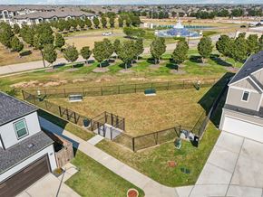 Katy apartment for rent - an aerial view of a fenced in dog park with a pool in the background