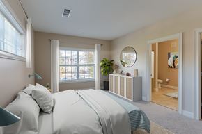 Highland apartment for rent - A bedroom with a large bed and a mirror on the wall.