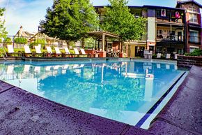 Kansas City apartment for rent - City Place at Westport - Outdoor Swimming Pool With Clear Water, Lounge Chairs, and Fenced Perimeter