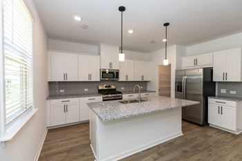 Linen white shaker style cabinets with matte black hardware
