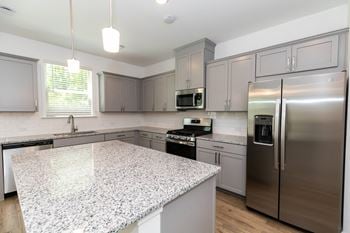 Stone grey shaker style cabinets with brushed nickel hardware