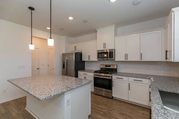Linen white shaker style cabinets with matte black hardware