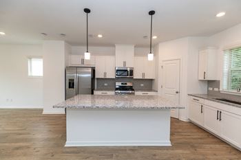 Linen white shaker style cabinets with matte  black hardware