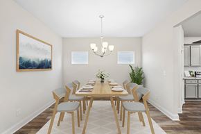 Hoschton townhouse for rent - Elegant dining room featuring a rich wooden table and timeless seating—designed for unforgettable family gatherings.