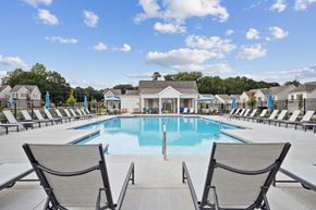 Powder Springs apartment for rent - Resort-style pool with lounge seating and a scenic backdrop.