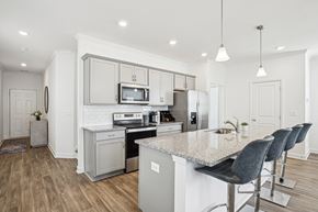 Powder Springs apartment for rent - View of the kitchen and entry hallway. Offering bar seating, plenty of cabinet space and granite countertops.