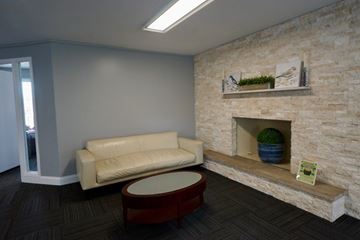 Lombard apartment for rent - A living room with a white couch and a stone fireplace.