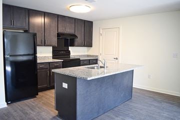 Medford apartment for rent - a kitchen with black appliances and a granite counter top