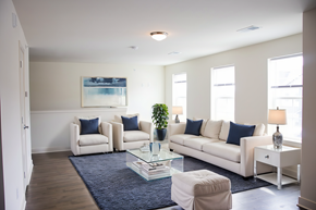 Stewartsville apartment for rent - A living room with a white couch, two chairs, and a glass coffee table.