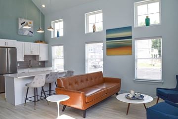 Elkton apartment for rent - a living room with a couch and a kitchen with a table and chairs