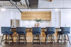 Prattville apartment for rent - a kitchen with a long table with blue chairs at The Mill at Prattville, Prattville, 36067