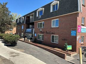 Denver apartment for rent - The image shows a multi-story building with a sign that reads "Dist. of Multnomah" and a phone number "2910" on the front.