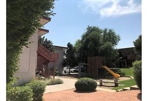 Lakewood apartment for rent - a backyard with a playground and a swing