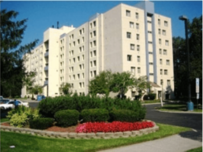 Ypsilanti apartment for rent - a large white building with a garden in front of it