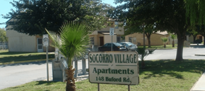 El Paso apartment for rent - A sign for SoCroKro Village Apartments stands in front of a tree.