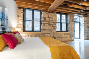 St. Louis apartment for rent - a bedroom with a bed and a stone wall