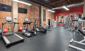 St. Louis apartment for rent - a gym with weights and cardio equipment in a brick wall