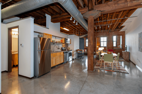 St. Louis apartment for rent - a large kitchen with stainless steel appliances and a dining table